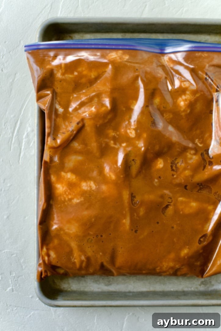 Authentic Al Pastor Tacos 4 Marinated chicken thighs (similar to pork preparation) soaking in a flavorful asado sauce inside a zip-top bag.