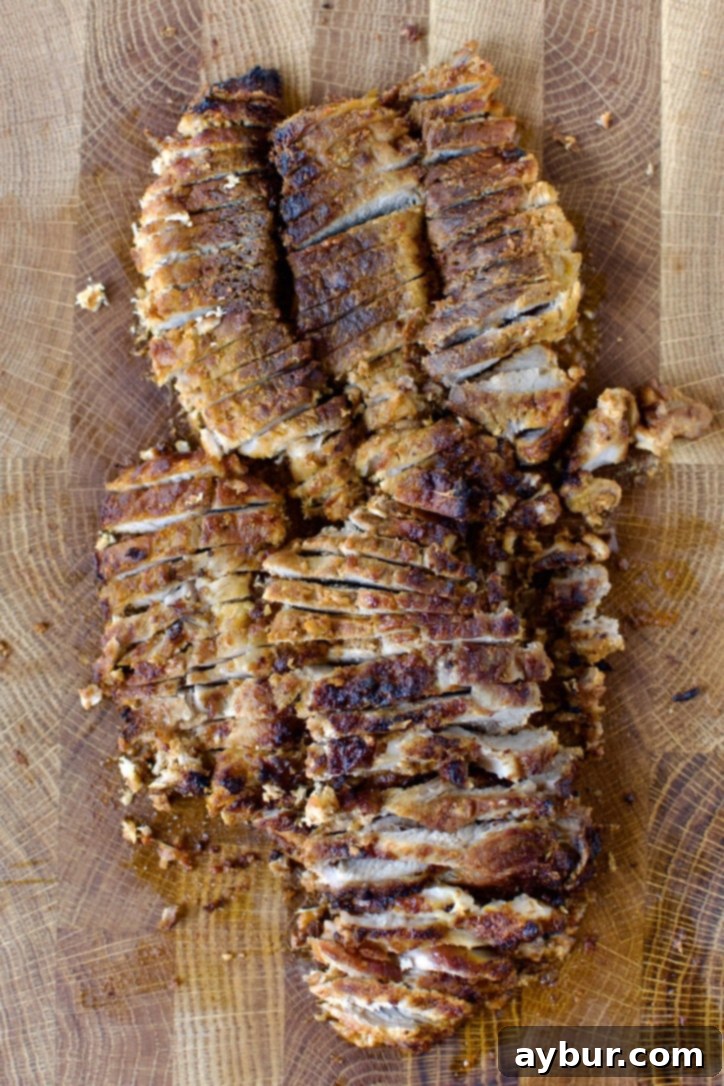 Authentic Al Pastor Tacos 7 Juicy, sliced Al Pastor pork after being roasted, ready for tacos.