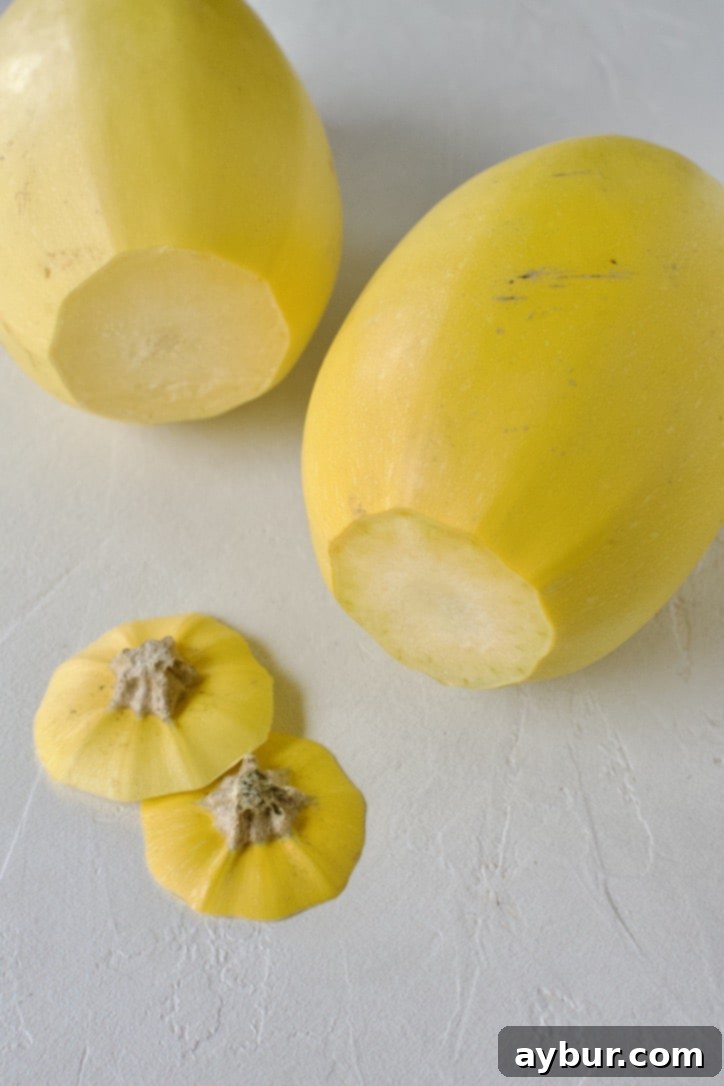 Spaghetti squash with its tough stem end carefully removed, preparing it for safer slicing.