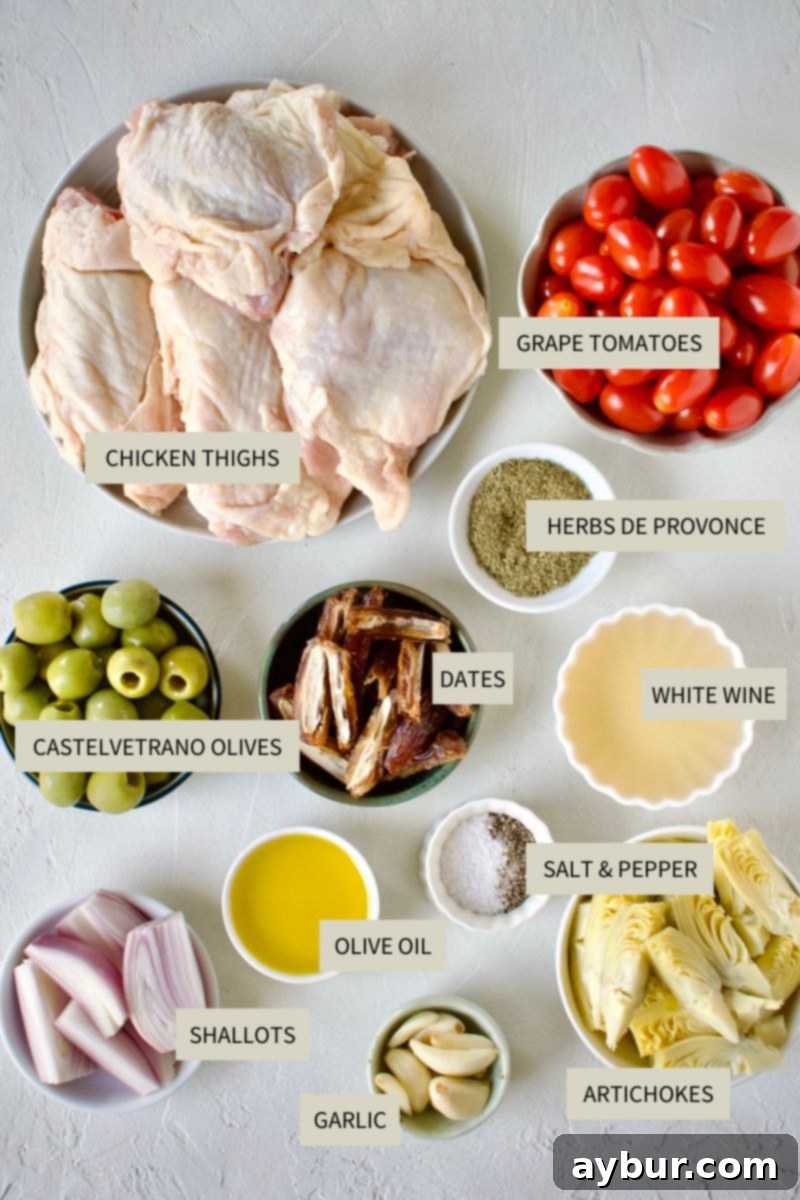 Mediterranean Herb Roasted Chicken 3 Fresh ingredients laid out for Chicken Provencal, including chicken thighs, olives, tomatoes, and herbs.