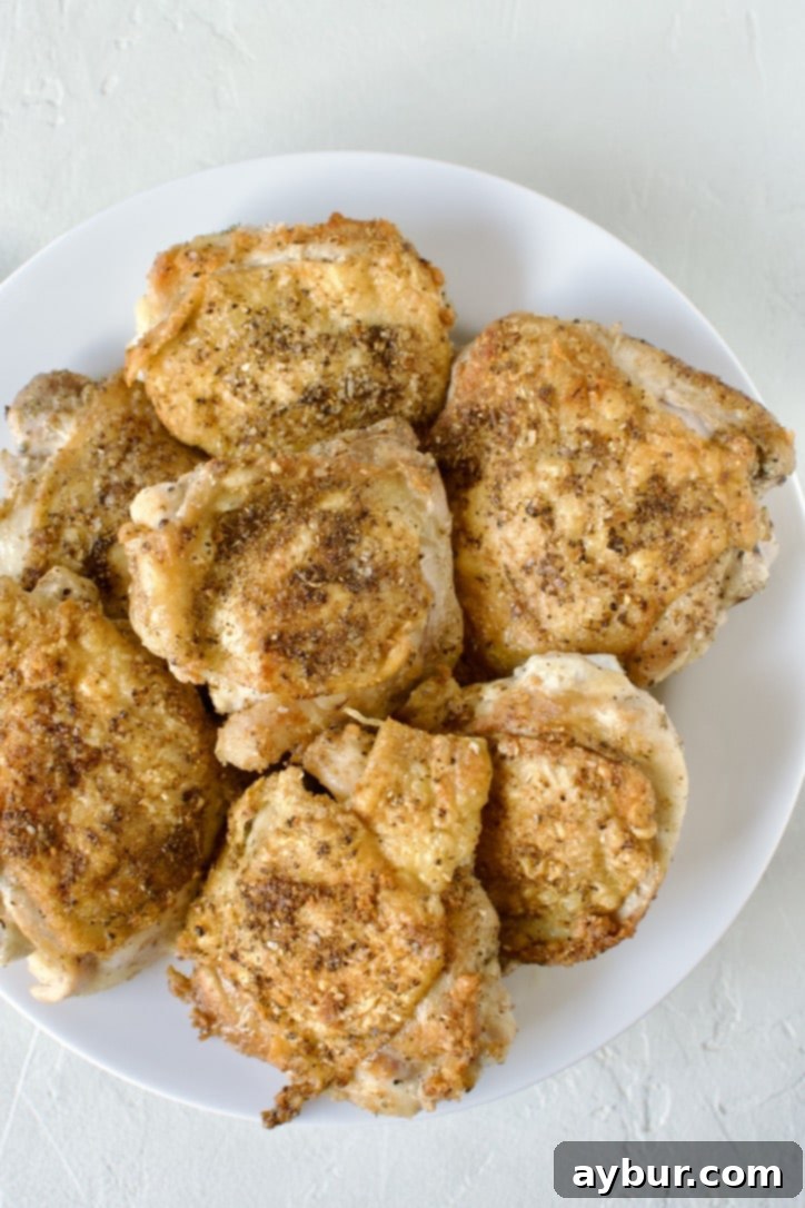 Mediterranean Herb Roasted Chicken 4 Beautifully seared chicken thighs resting on a plate, ready for the next step of the Chicken Provencal recipe.