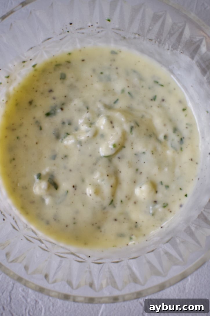 Well-mixed garlic butter, rich and fragrant, ready to be generously spread onto the ciabatta bread.