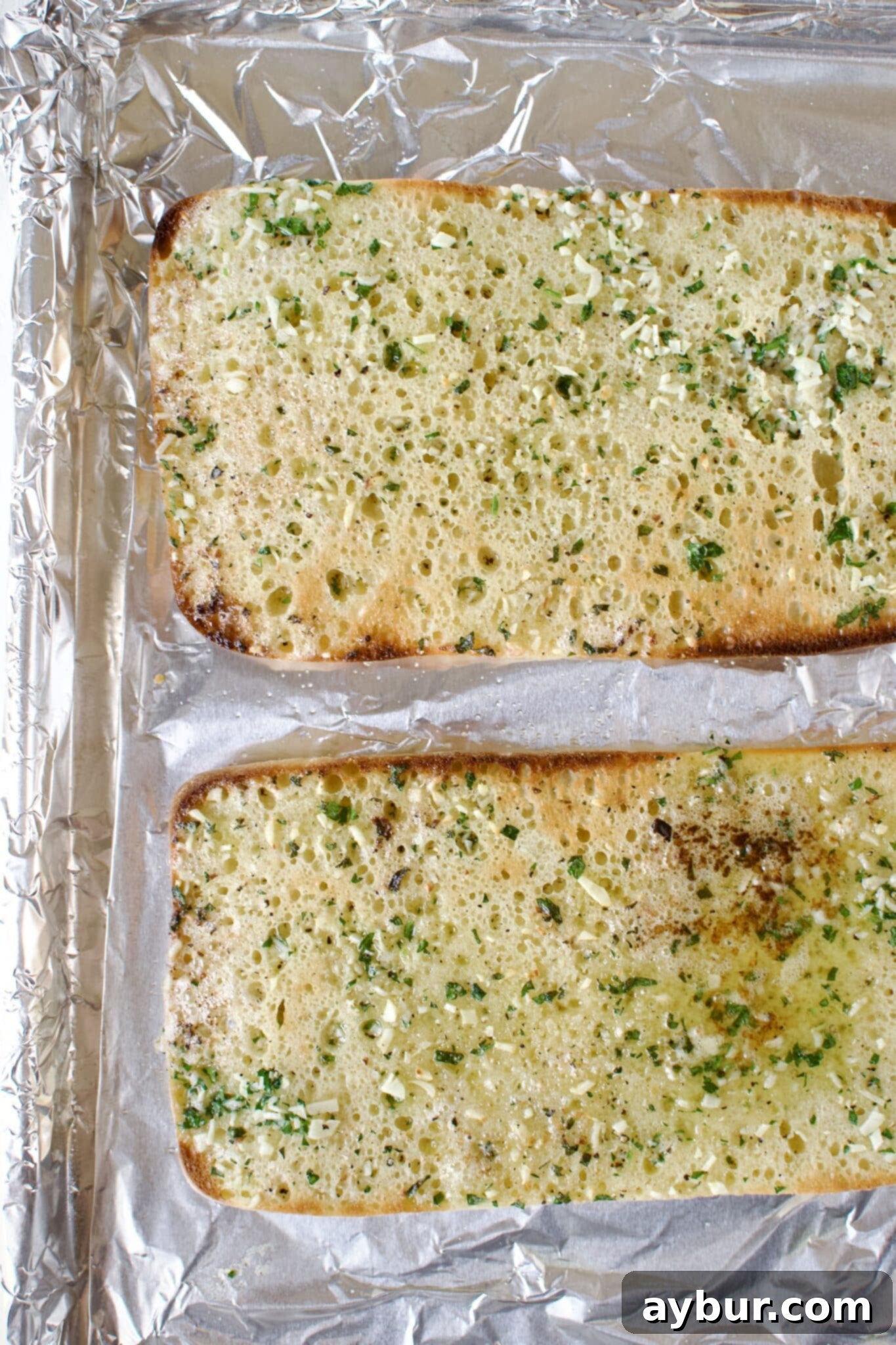 The ciabatta bread after its initial toasting, lightly browned and crisp.