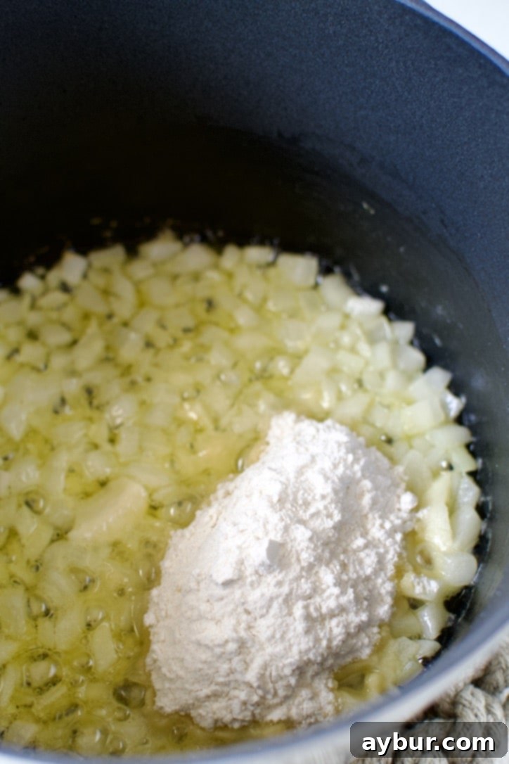 Homemade Red Enchilada Sauce 4 Finely diced onions and smashed garlic are gently cooked in melted butter in a saucepan, slowly becoming soft and translucent to create a flavorful base for the enchilada sauce.