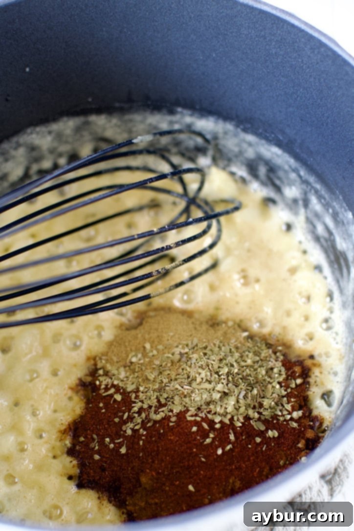 Homemade Red Enchilada Sauce 5 After the roux is formed, the Ancho chili powder, cumin, and oregano are added to the saucepan, ready to be bloomed in the hot butter and flour mixture.