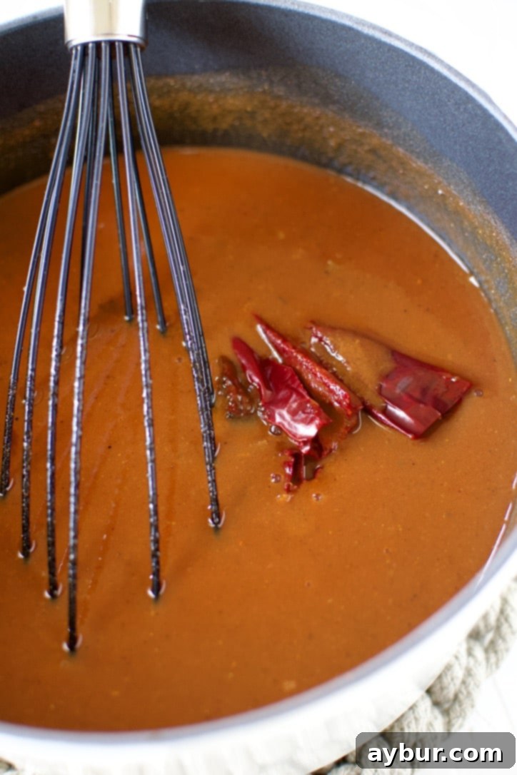 Homemade Red Enchilada Sauce 7 Chicken stock, tomato sauce, dry guajillo chili, and chipotle pepper in adobo are added to the pot and gently brought to a simmer, allowing all the flavors to meld and deepen.
