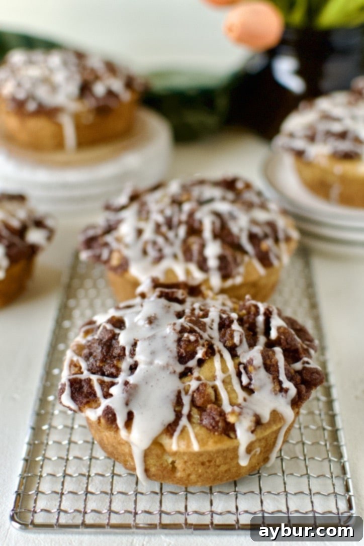 Golden Apple Crumb Muffins 2 Glazed Apple Streusel Muffins on a table displayed and ready to eat.
