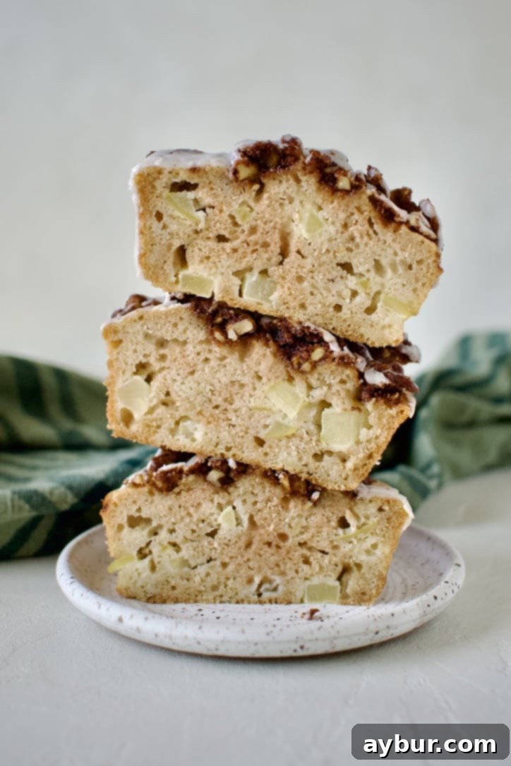 Golden Apple Crumb Muffins 14 Sliced open muffins stacked on top of each other.