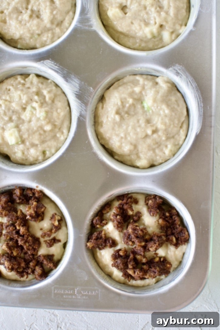 Golden Apple Crumb Muffins 7 Batter placed in the butter pan and topping with the streusel.