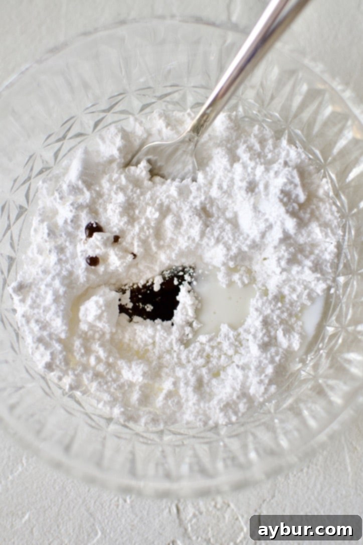 Golden Apple Crumb Muffins 8 Glaze ingredients in a bowl with a fork.