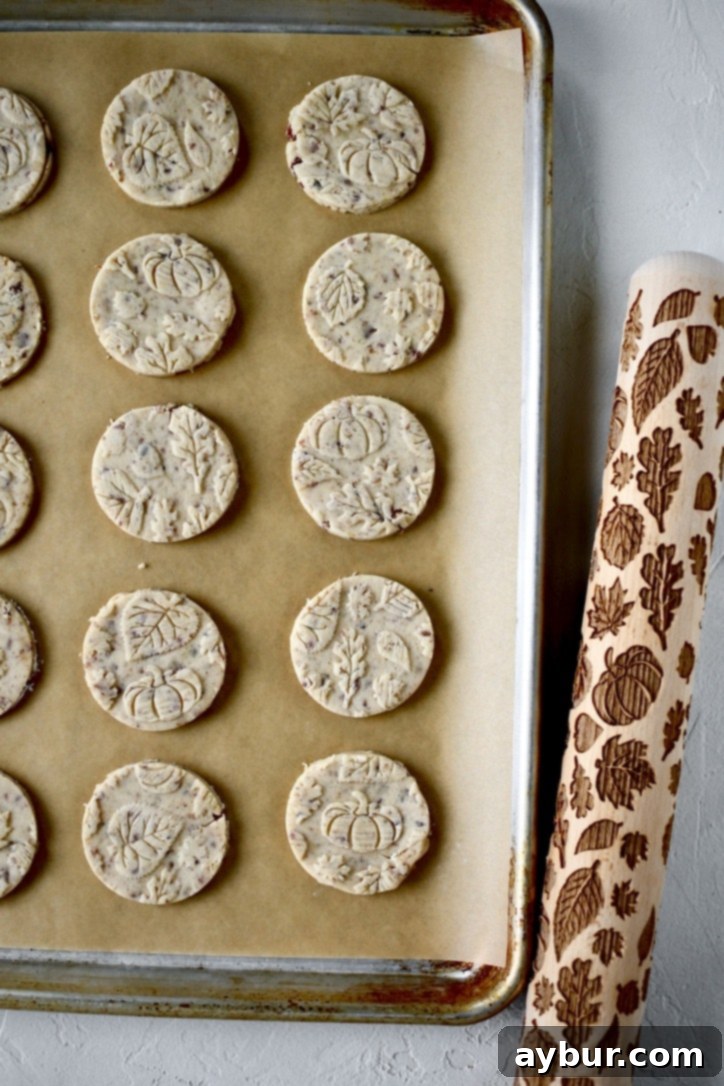 Unbaked Pecan Shortbread Cookies, cut into charming shapes and arranged on a baking sheet, ready for the oven.