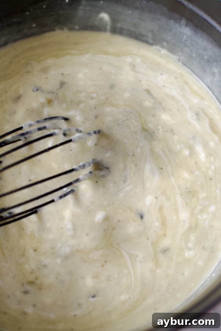 Velvety Sour Cream Enchilada Sauce 6 Smoothly whisking the sour cream into the creamy sauce.