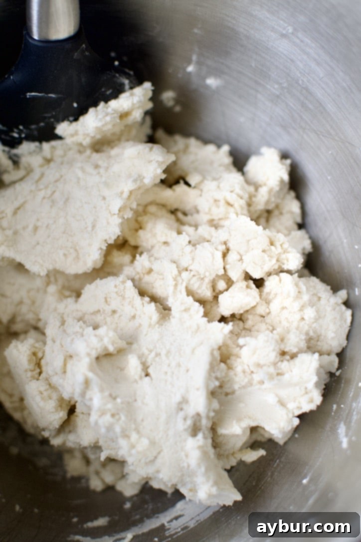 Spiced Pumpkin Delights 4 Step-by-step image of butter, sugars, and extracts being creamed in a stand mixer.