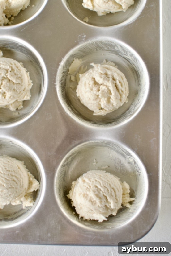 Spiced Pumpkin Delights 7 A jumbo muffin tin with portions of shortbread dough pressed into each well, forming wells for the filling.