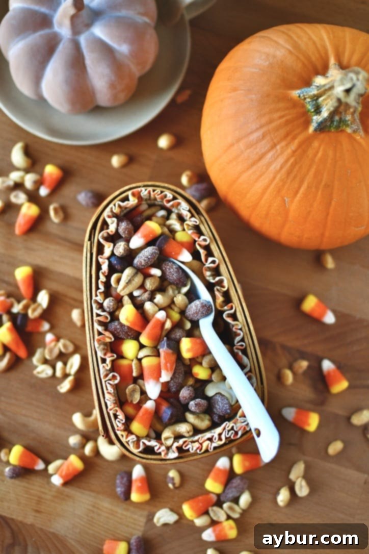 A vibrant display of fall-themed decorations including pumpkins and leaves, with the snack mix visible.