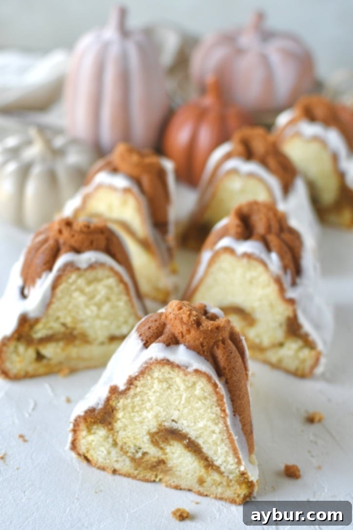 Pumpkin Spice Swirl Pound Cake 2 Pumpkin Pound Cake sliced on a table ready to eat.