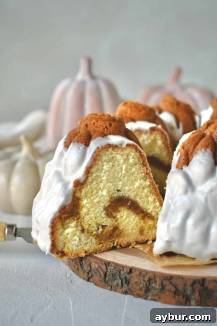 Pumpkin Spice Swirl Pound Cake 16 Pumpkin Pound Cake with a slice being removed from the bundt that looks like pumpkins in a field.