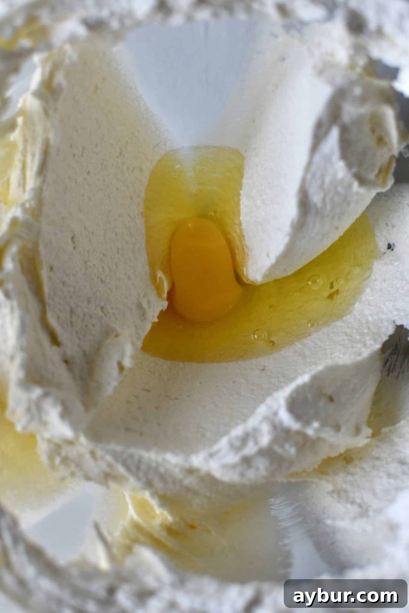 Pumpkin Spice Swirl Pound Cake 4 Wet ingredients for pound cake creamed together in a stand mixer bowl. Adding the egg.