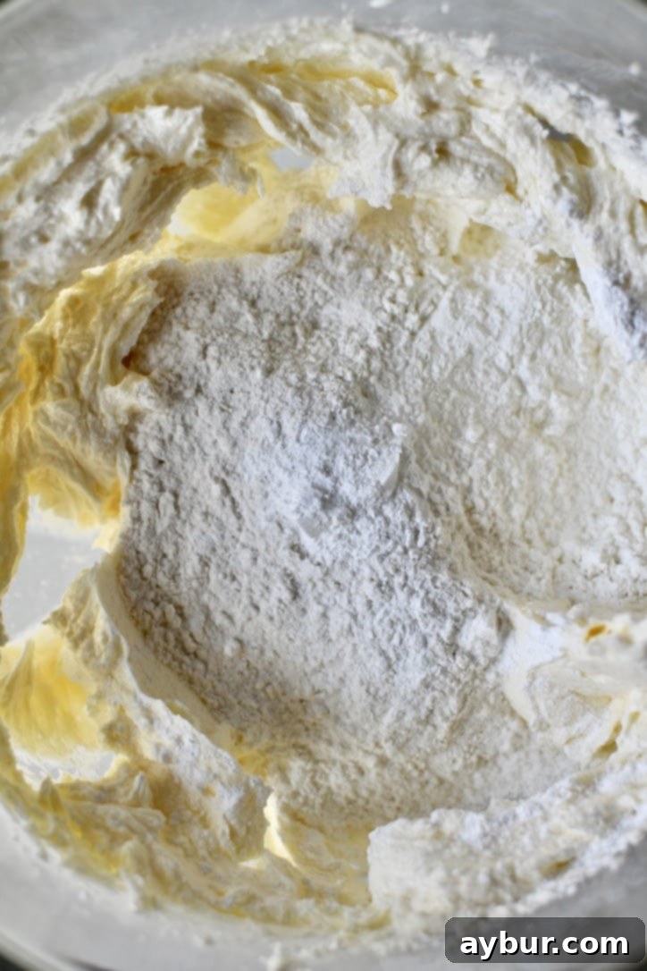 Pumpkin Spice Swirl Pound Cake 5 Adding the dry ingredients to the wet in a stand mixer bowl.