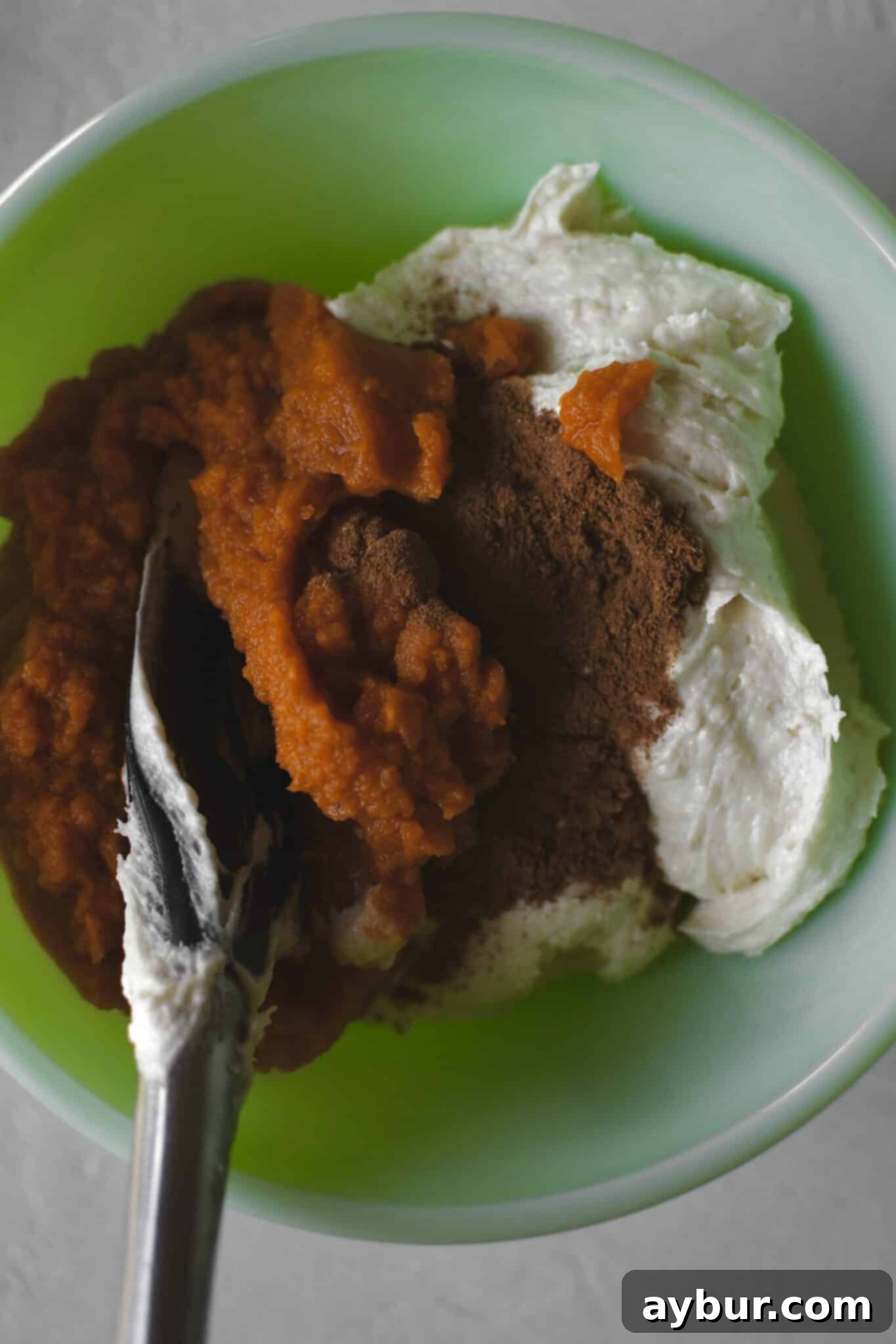 Pumpkin Spice Swirl Pound Cake 7 Some pound cake batter removed to a secondary bowl, folding in the pumpin and spices.