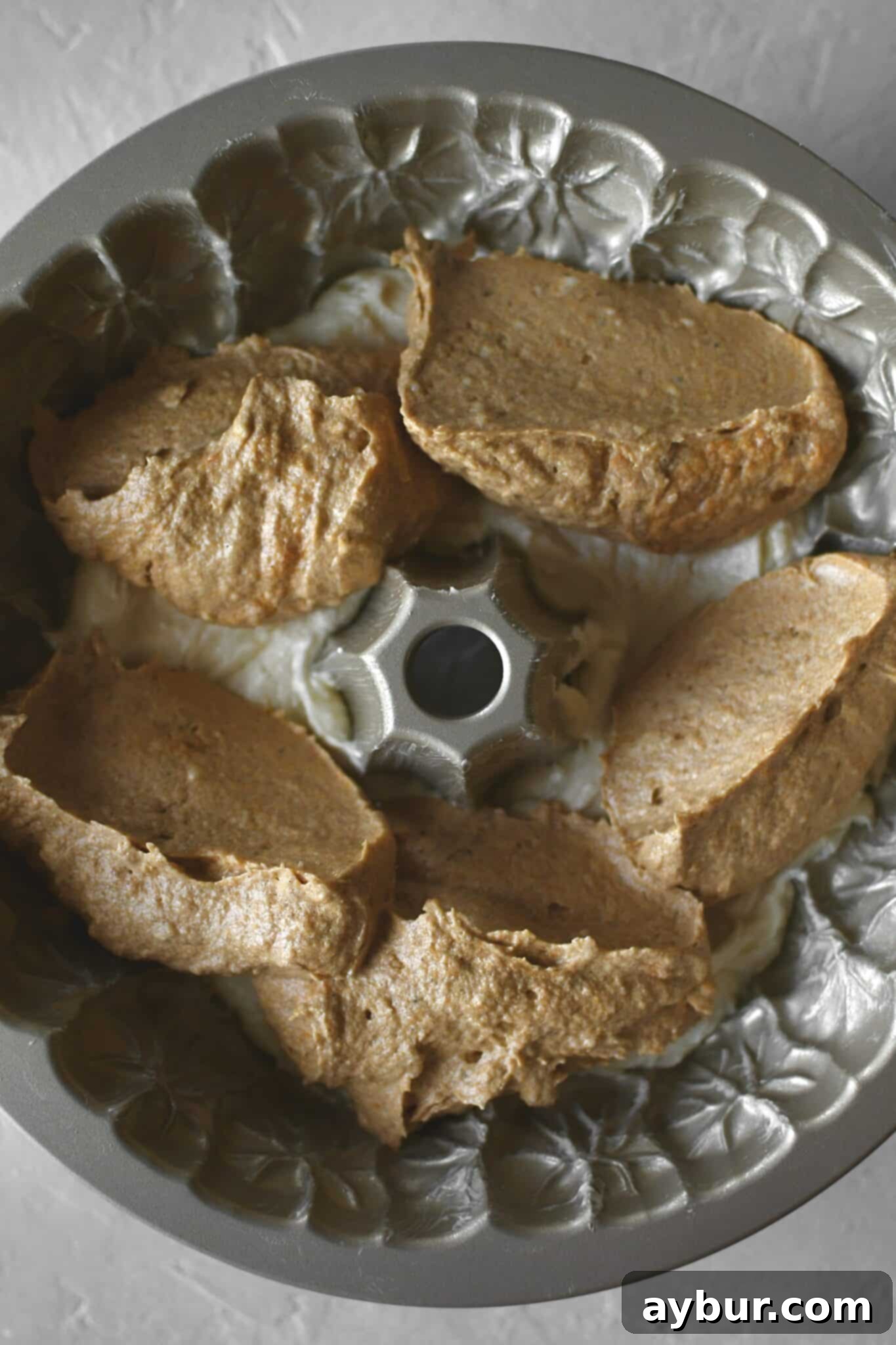 Pumpkin Spice Swirl Pound Cake 10 Layering the cake in the bundt pan, starting with the plain cake and dolloping pumpkin cake on top.