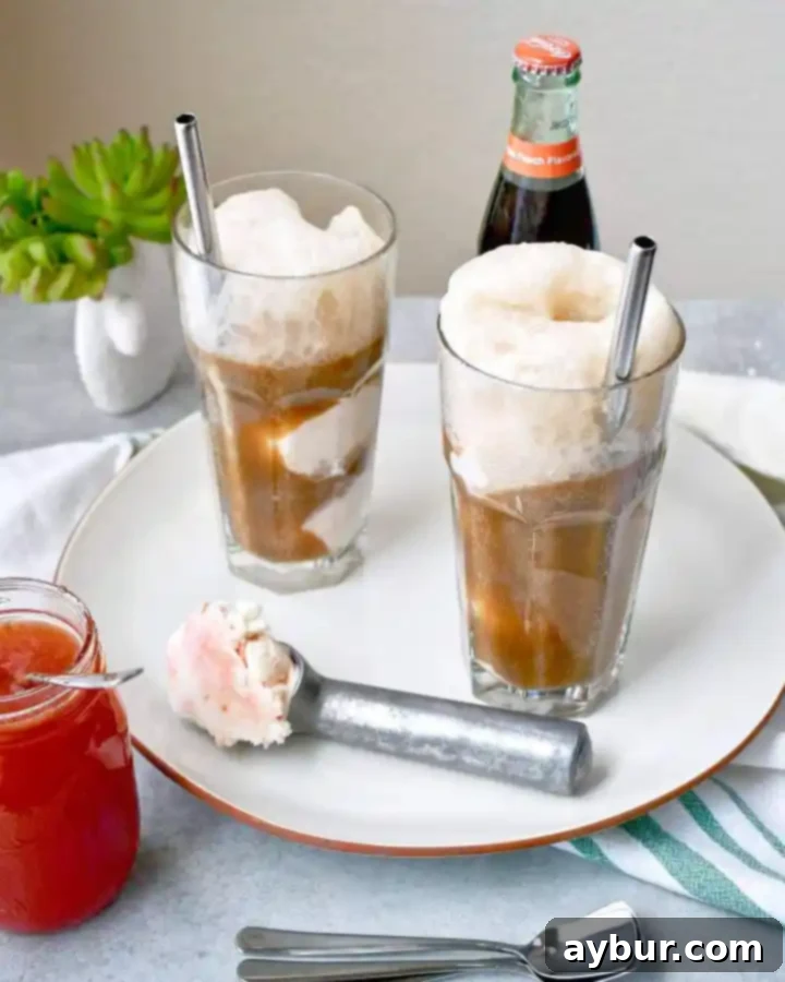 Creamy Fizz Delight 6 A hand holding a glass of Peach Jam Ice Cream Soda with a view of a kitchen