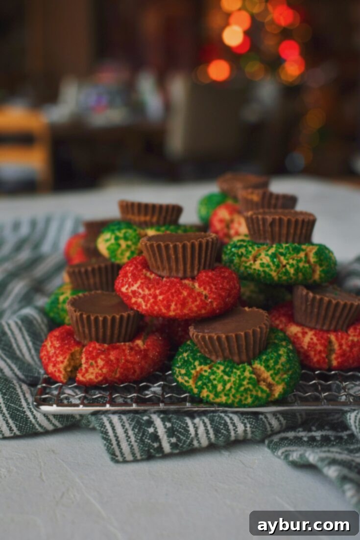 Peanut Butter Cup Cookies on a rack, with a christmas tree in the background.