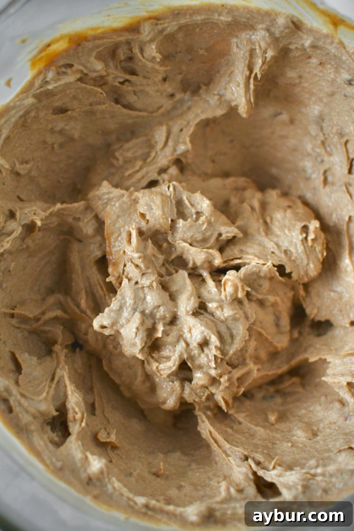 Creamed butters and sugars in a stand mixer bowl.