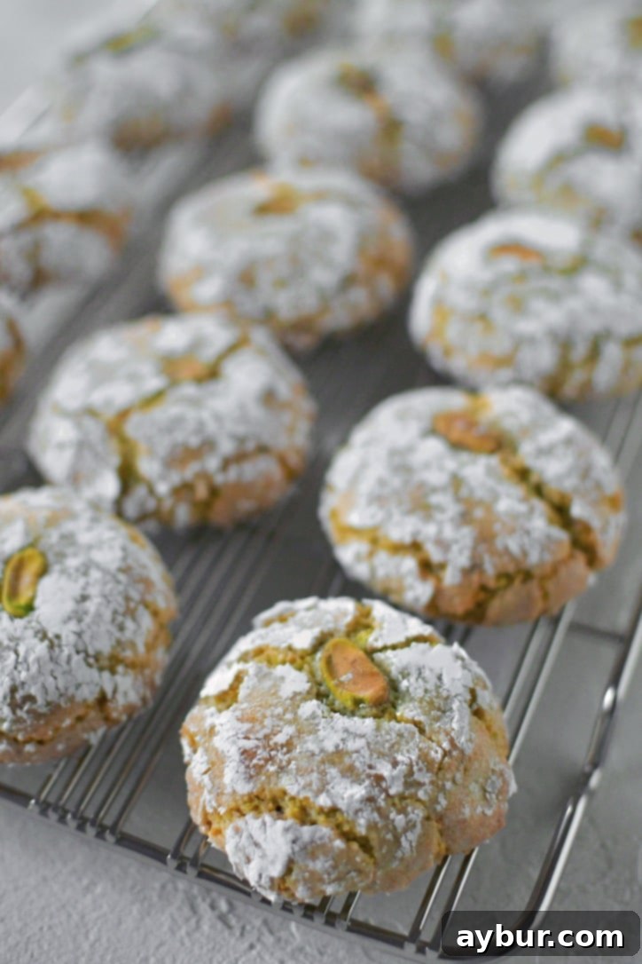 Freshly baked Pistachio Amaretti Cookies cooling on a wire rack, ready to be enjoyed.