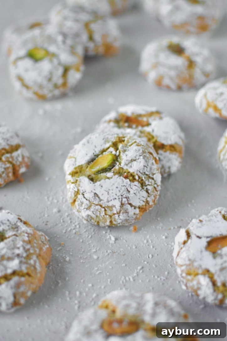 A close-up of a stack of cooled Pistachio Amaretti Cookies, perfectly baked and ready for serving.
