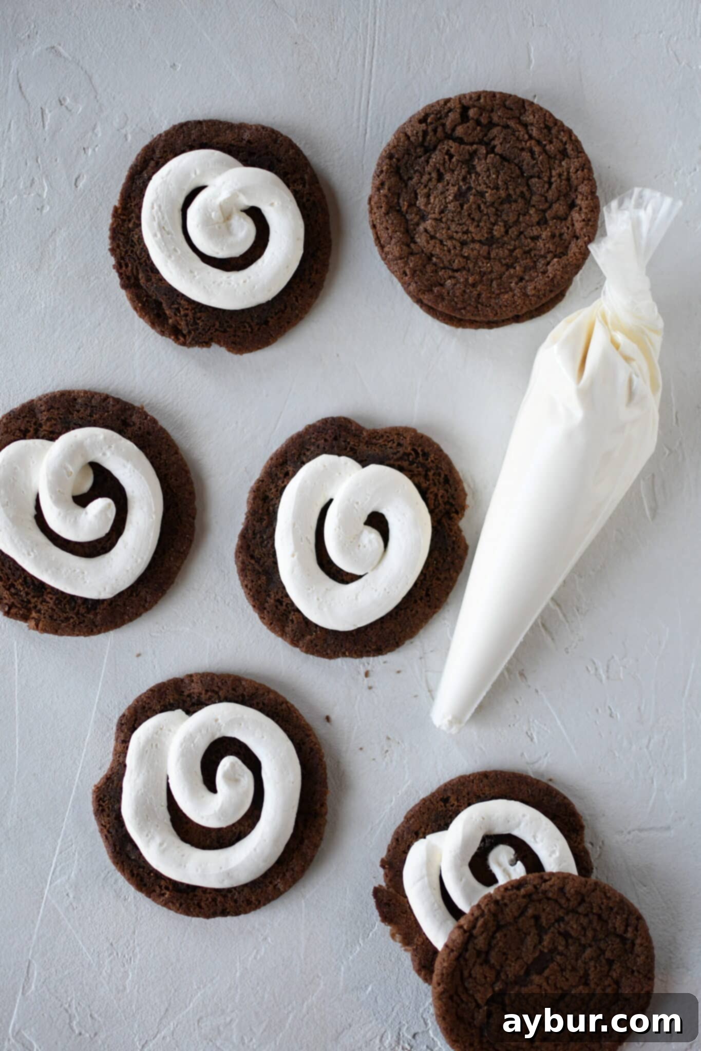 Peppermint Chocolate Delights 10 A pipe bag expertly filling a chocolate peppermint cookie with peppermint marshmallow cream.