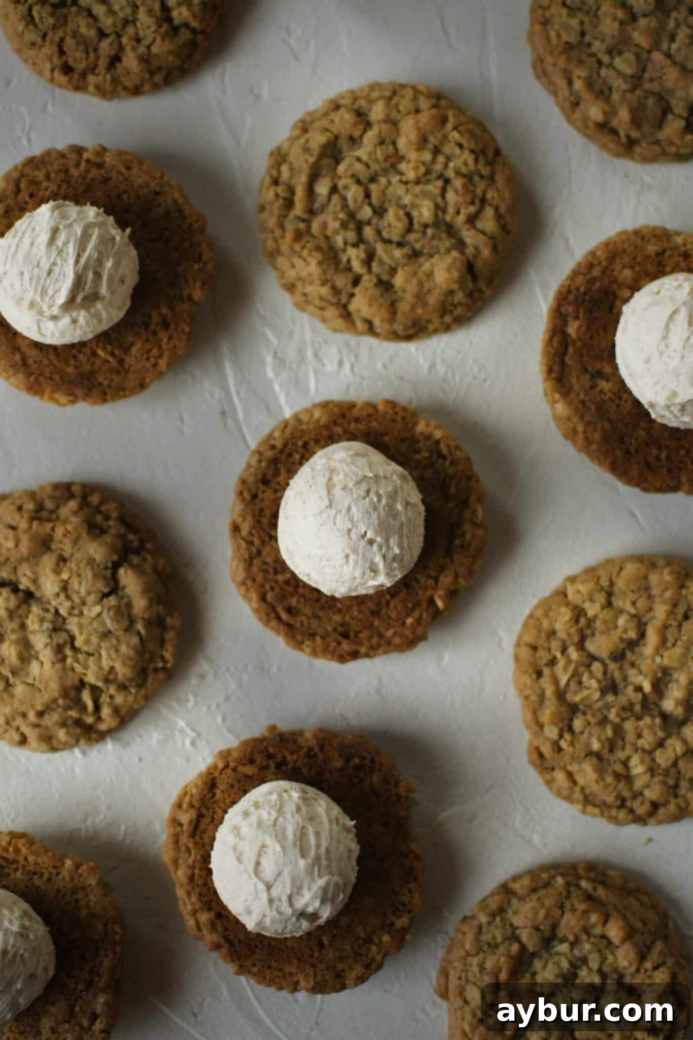 Gingerbread Oatmeal Whoopie Pies 13 Creamy filling being carefully placed onto gingerbread oatmeal cookies, preparing them to be sandwiched into cream pies.