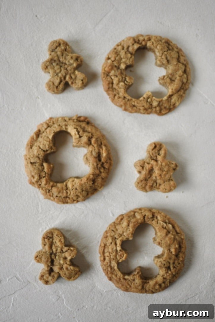 Festive Gingerbread Oatmeal Cream Pies 15 Several gingerbread oatmeal cookies with charming gingerbread men shapes carefully cut out of their centers.