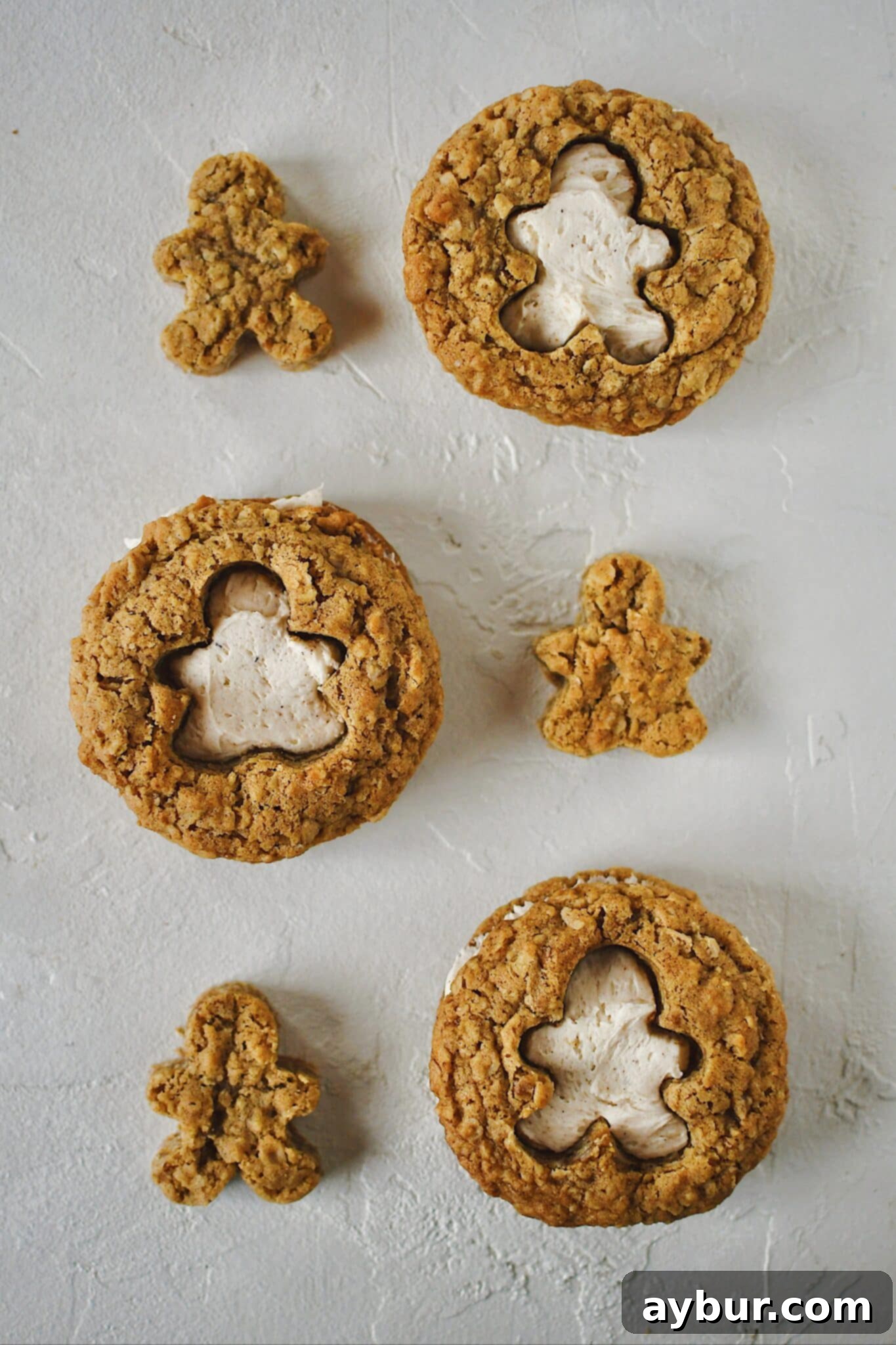 Festive Gingerbread Oatmeal Cream Pies 16 A beautifully assembled Gingerbread Oatmeal Cream Pie with a gingerbread man cutout, showcasing the creamy filling peeking through, highlighting its festive design.