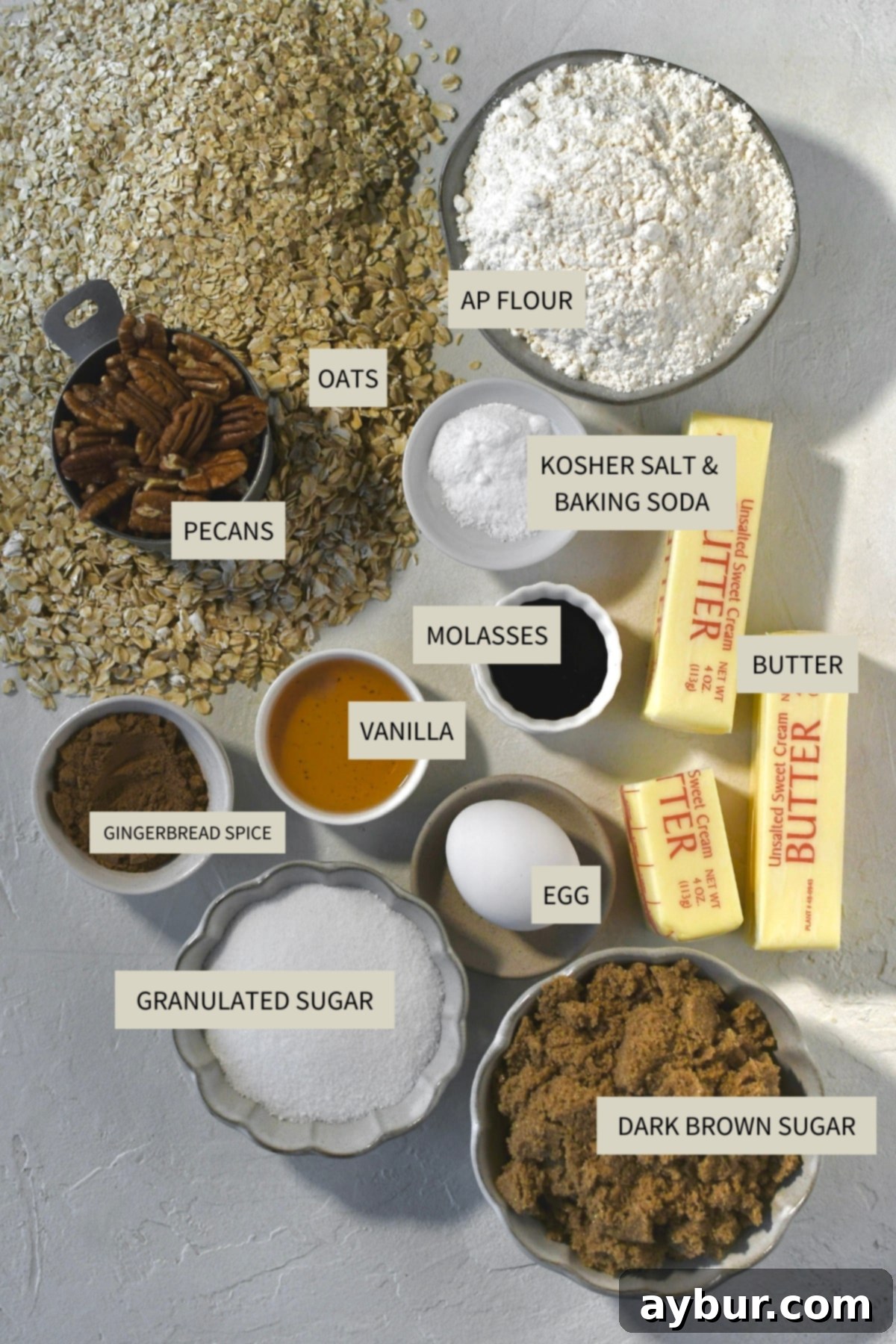 Gingerbread Oatmeal Whoopie Pies 3 A collection of ingredients laid out, featuring flour, oats, sugars, butter, eggs, and spices, essential for baking Gingerbread Oatmeal Cream Pies.