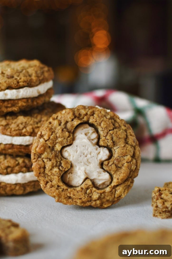 Festive Gingerbread Oatmeal Cream Pies 22 A Gingerbread Oatmeal Cream Pie, artfully cut with a gingerbread man shape, revealing the white cream filling, presented as a delightful and festive holiday dessert.