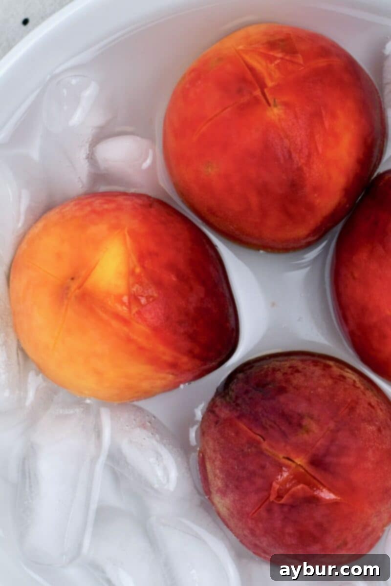 Delicious Homemade Peach Jam 6 Whole peaches after blanching, ready for peeling.