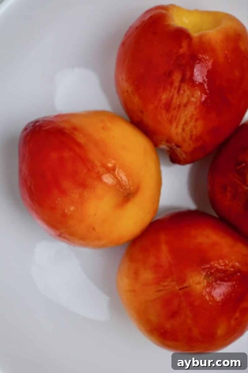 Delicious Homemade Peach Jam 7 Whole peaches after blanching and peeling.