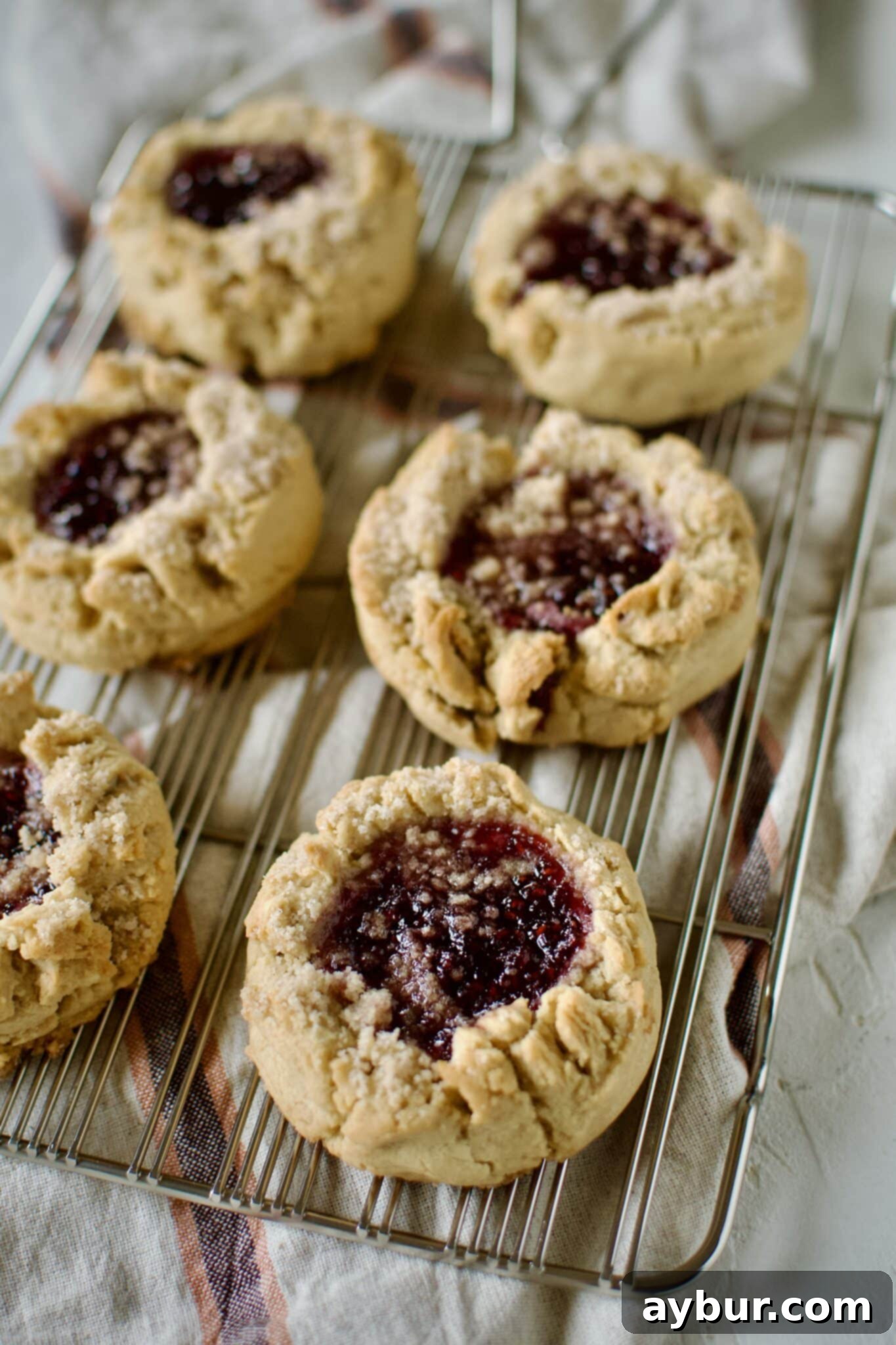 Peanut Butter Jelly Dream Cookies 12 Peanut Butter and Jelly Cookies on a cooling rack.