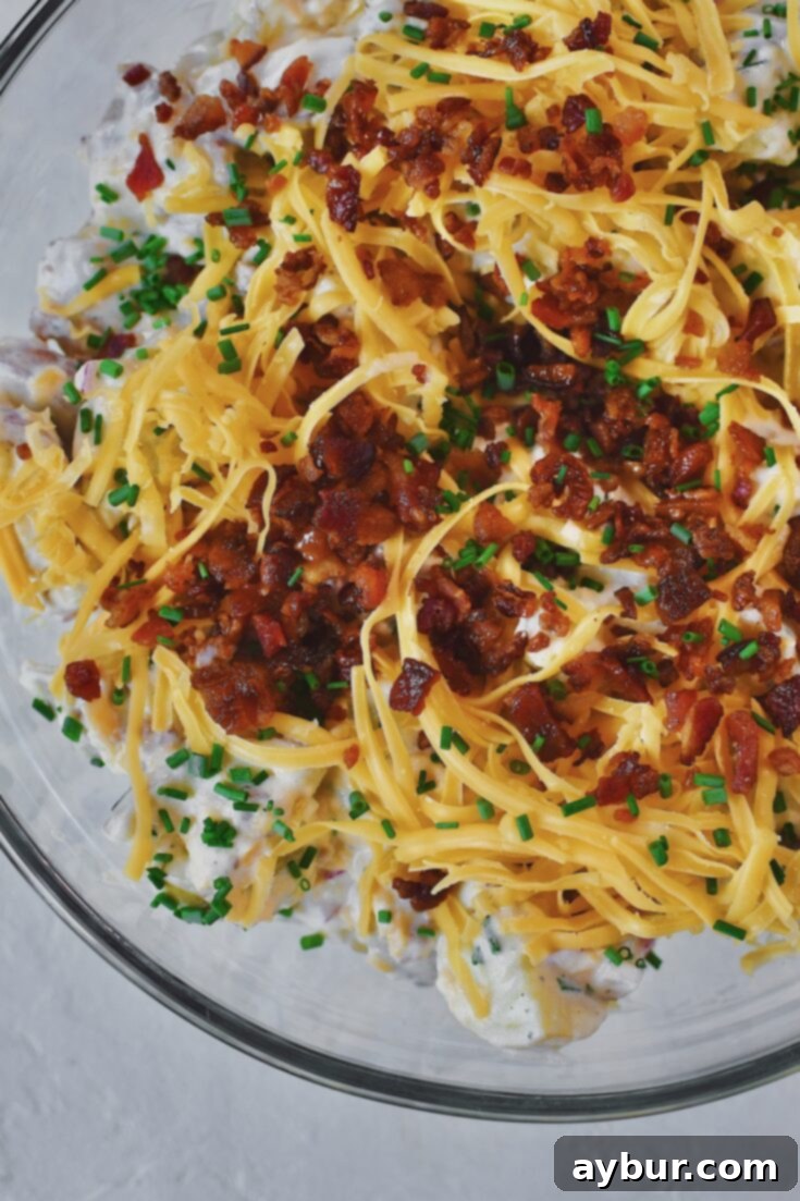 Creamy Ranch Potato Salad 12 Ranch Potato Salad in a glass bowl topped with chives, bacon, and cheddar. Ready to serve.