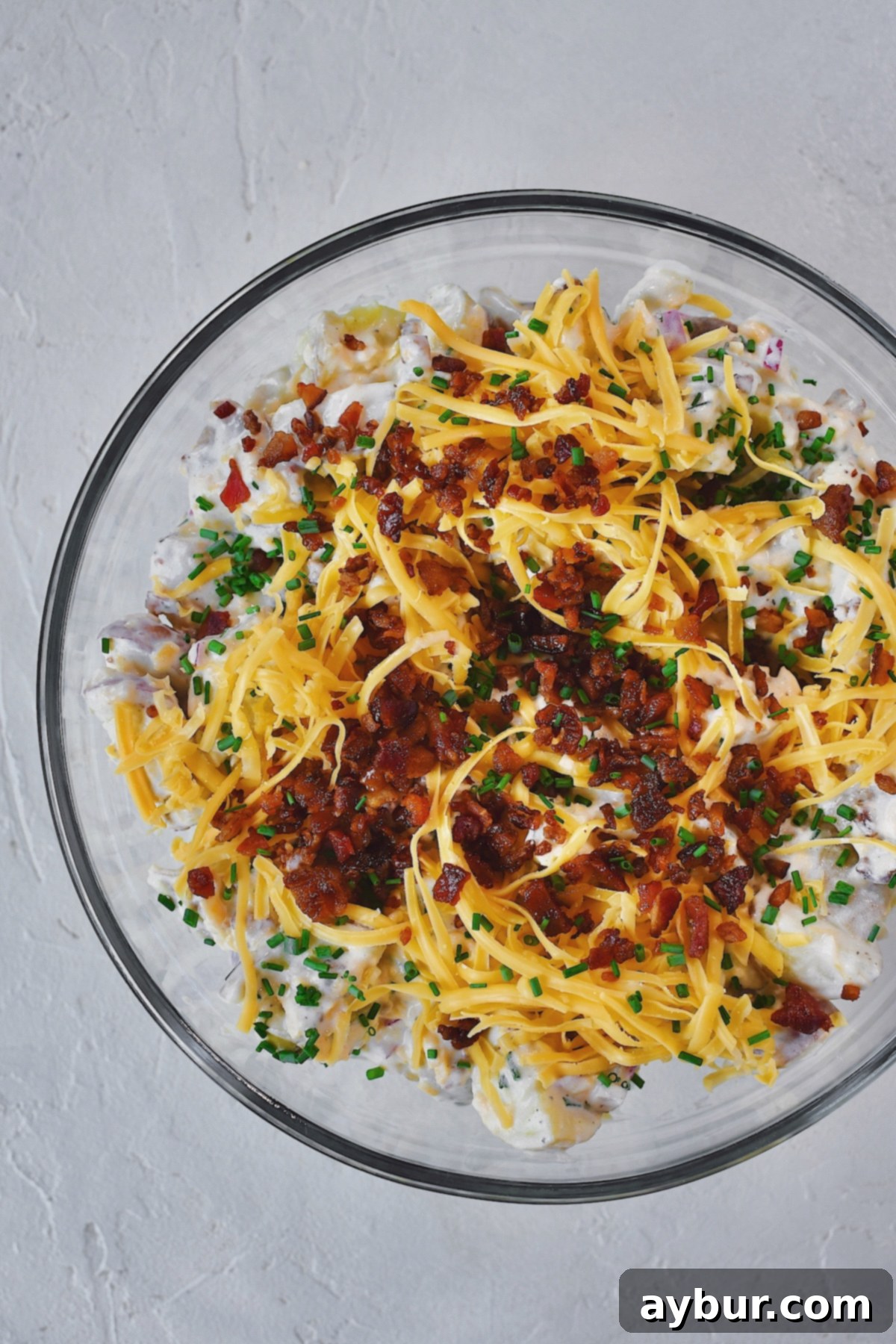Creamy Ranch Potato Salad 10 Ranch Potato Salad in a bowl topped with chives, bacon, and cheddar, ready to eat!