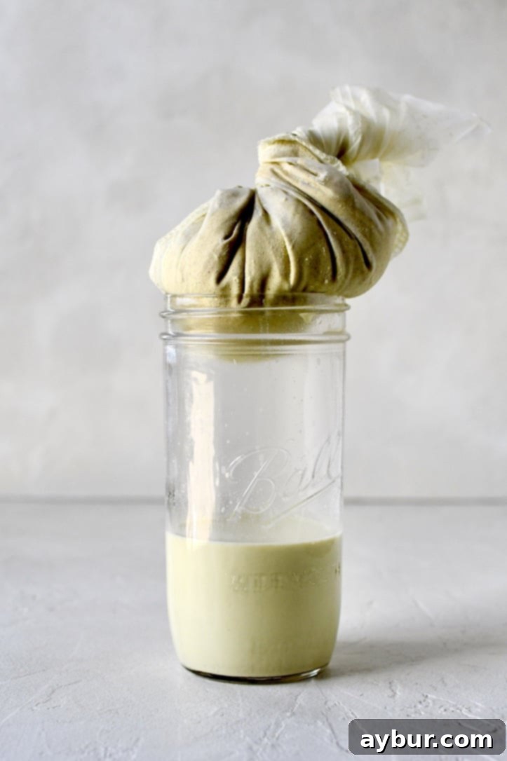 Pistachio Elixir 4 Straining pistachio milk through a nut milk bag to achieve a smooth consistency.