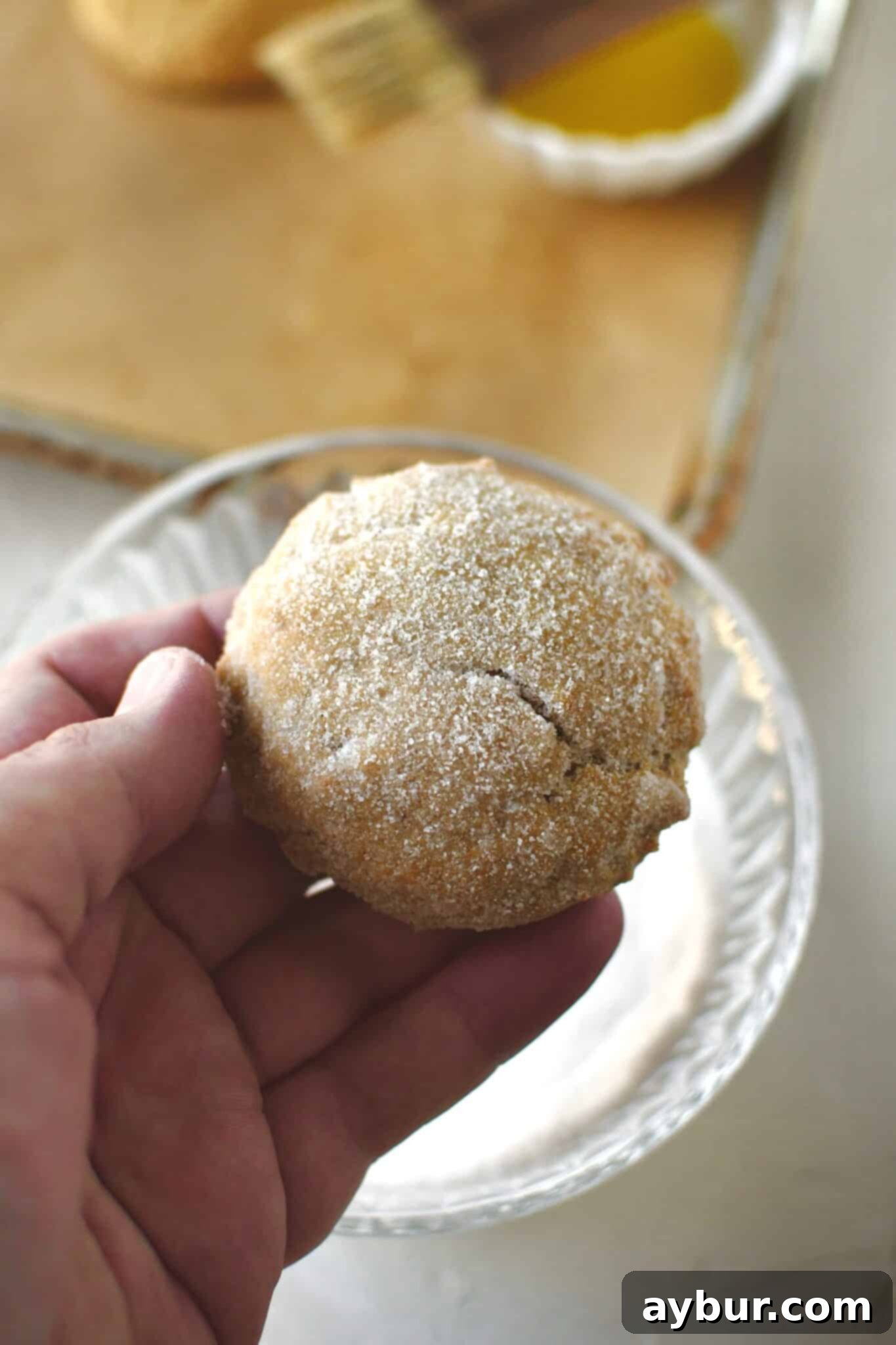 A single pumpkin whoopie pie half, perfectly coated in the spiced sugar, ready for filling.
