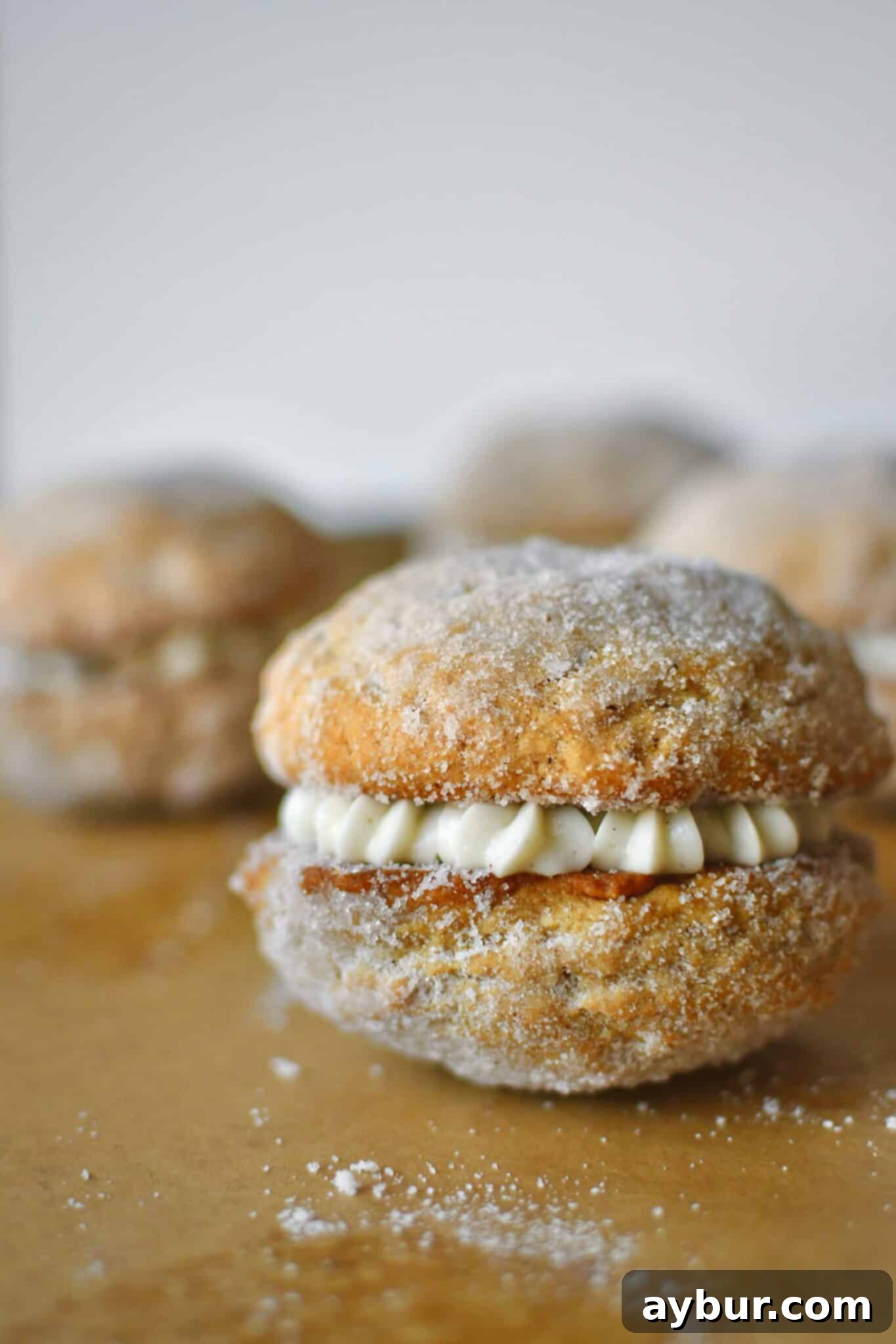A Pumpkin Whoopie Pie fully assembled on a baking sheet.