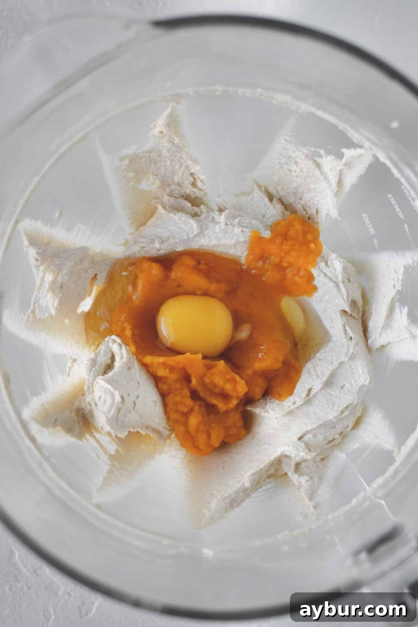 Creamed butter and sugar in the bowl of a stand mixer, adding the pumpkin and egg.