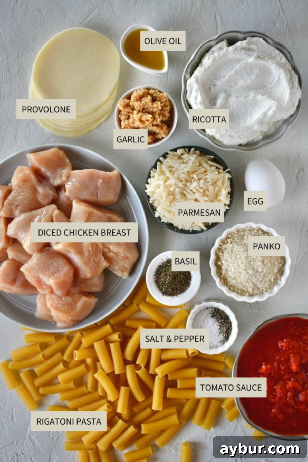 Flavorful Parmesan Chicken Meatballs 3 A selection of fresh ingredients including chicken breast, ricotta, parmesan, garlic, and fresh basil, ready to be used for Parmesan Chicken Meatballs.