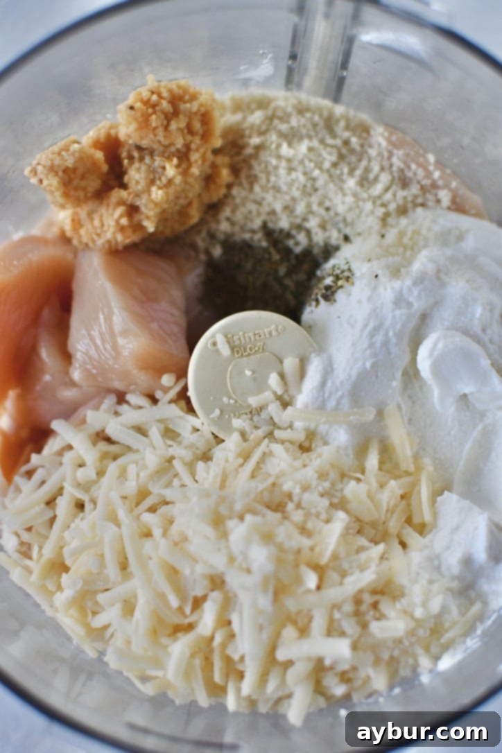 Flavorful Parmesan Chicken Meatballs 4 Roughly chopped chicken breast in a food processor, ready for blending.