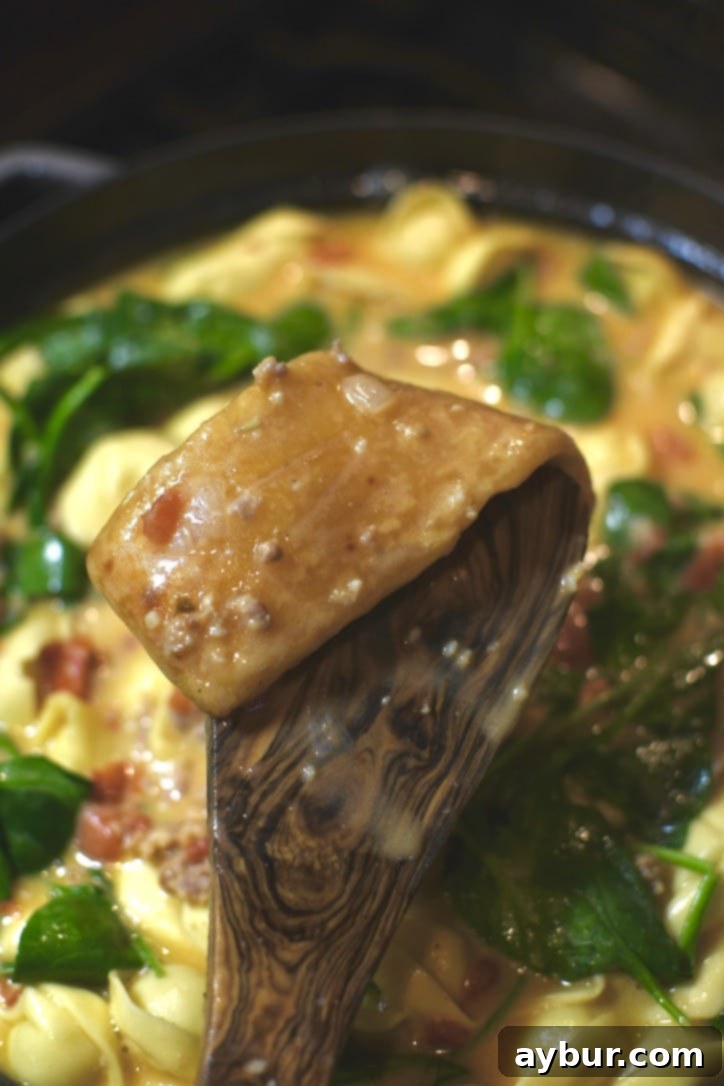 Removing the stewed parmesan rind from the soup pot.