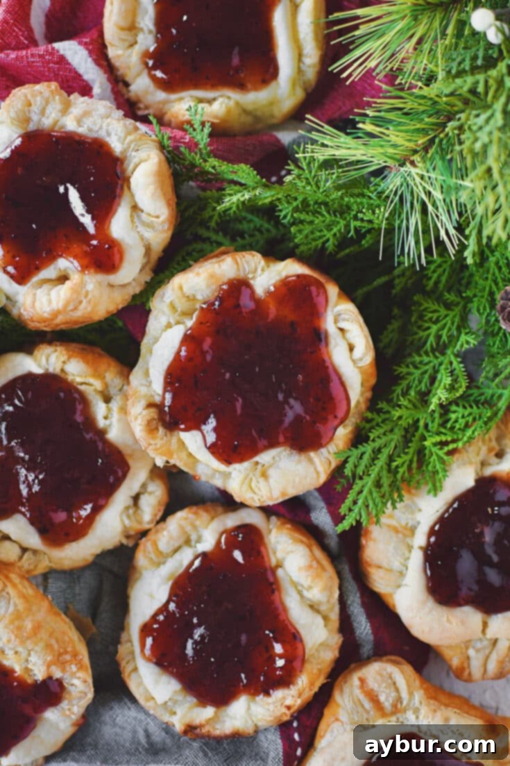 Sugar Plum Cheese Danish over a Christmas themed towel and some greens on the side.