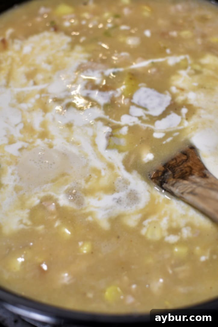 Heavy cream and corn stirred into the soup, finishing the chowder with rich creaminess and sweet corn kernels.